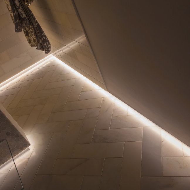 Close up of low level linear LED bathroom lighting
