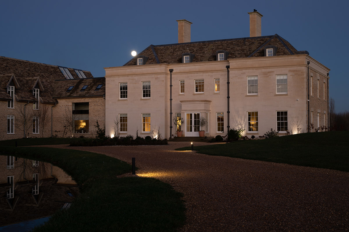 Lighting Design Pickwick outdoor shot of the grand front of the house at night, spotlights & pathlights