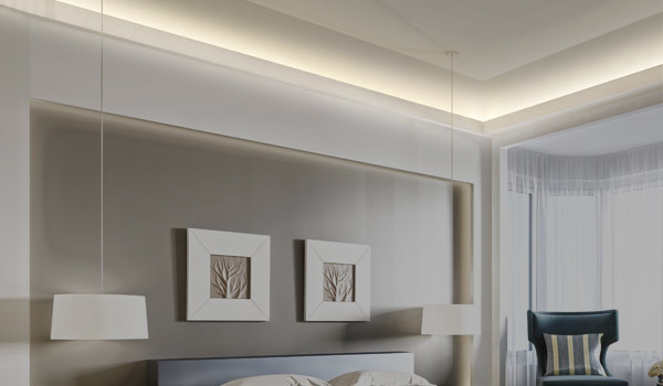 Coving & cornice lighting offering subtle warm uplighting onto the ceiling of a modern bedroom