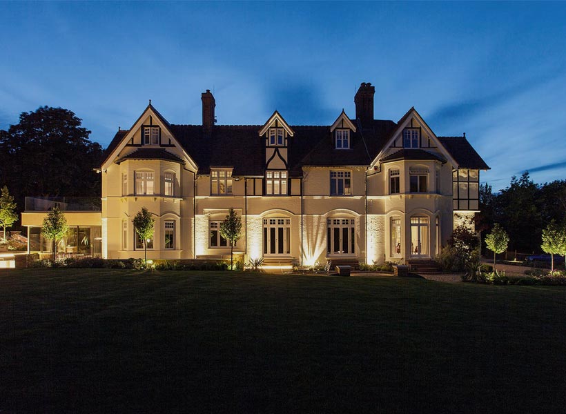 Project Portfolio: exterior of huge country home and grounds lit at night