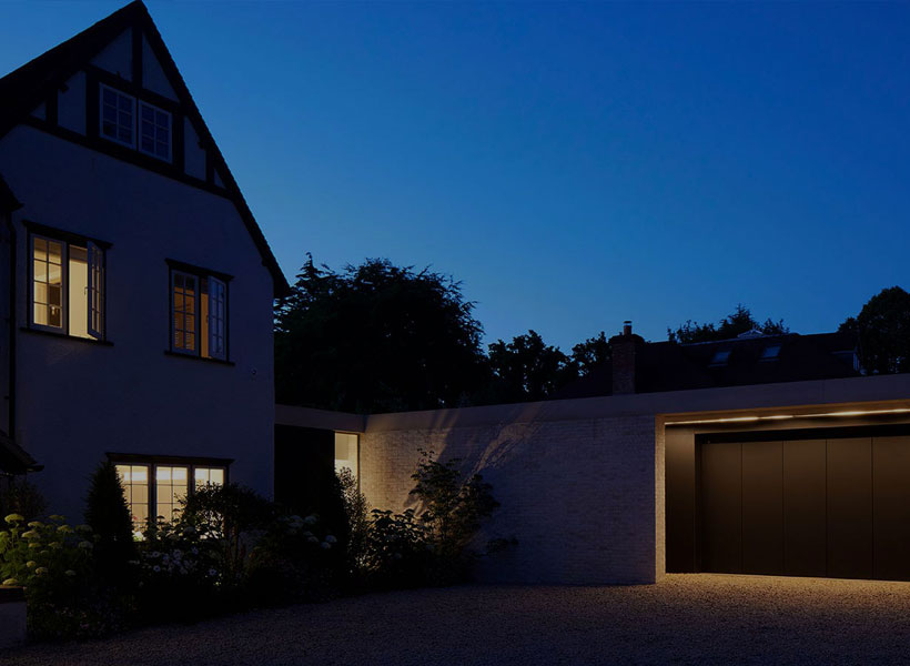 Project Portfolio: exterior of large home & garage at night