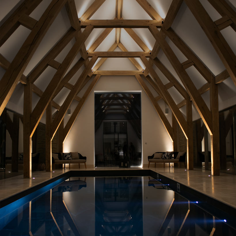 Book Your Consultation: indoor swimming pool housed in a large barn conversion with eaves lighting