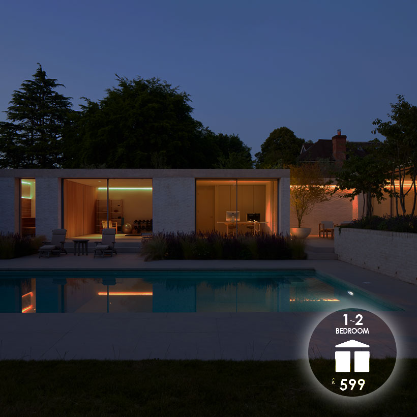 Lighting Design To Go: 1-2 bedroom package £599 exterior shot at night of a 2 room extension and swimming pool