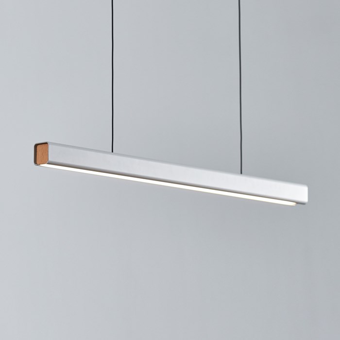 The Seed Design Mumu 120 Pendant in white and beech with black suspension cables, lighting over a grey background