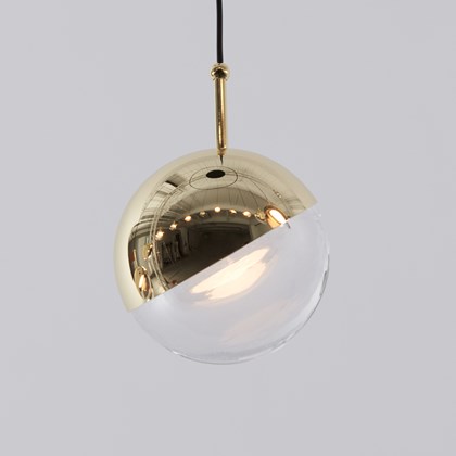 Seed Design Dora P1 spherical LED globe pendant in glass & brass on grey background