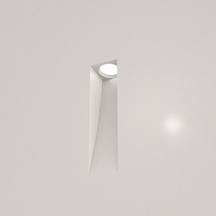 Nama Fos 15 Wall Light recessed and plastered into a plain grey wall, light switched on
