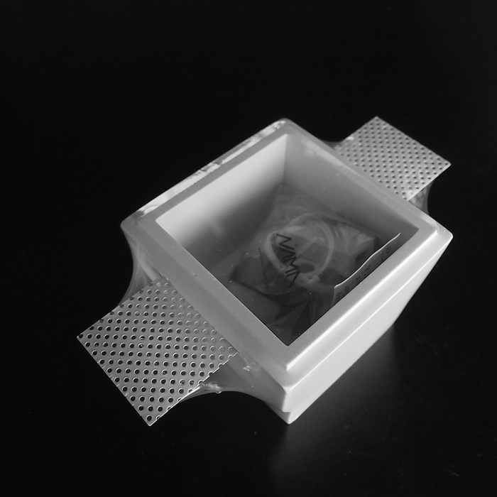 Nama Fos 07 Square Plaster In Downlight frame vacuum-packed on black background
