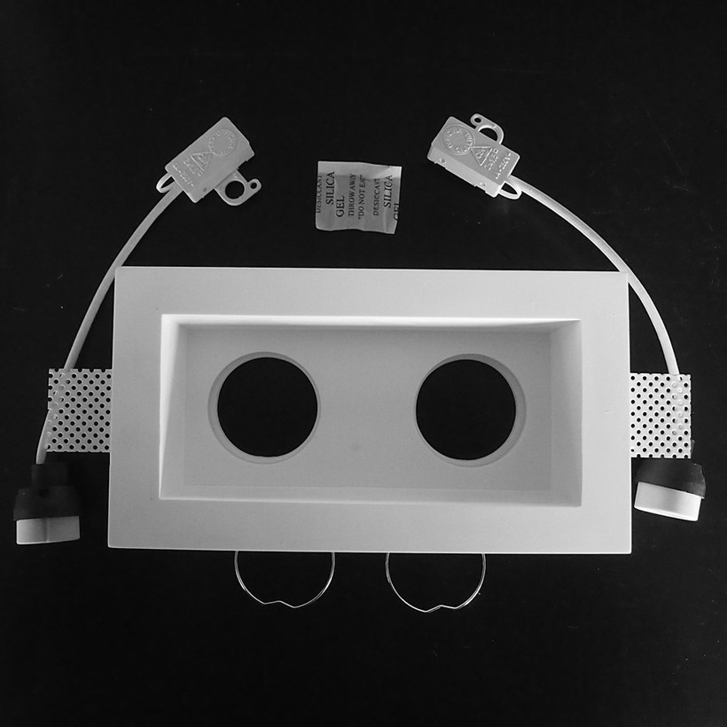 Component frame, lamp holder and fixings of the Nama Fos 09 Twin Plaster In Downlight on black background
