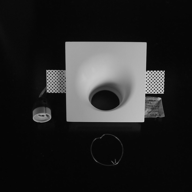 Component frame, lamp holder and fixings of the Nama Fos 10 Round Plaster In Wall Washer Downlight on black background