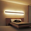 Eleni EL302 linear profile cornice used as a feature wall light above a minimalist kingsize bed in a contemporary bedroom