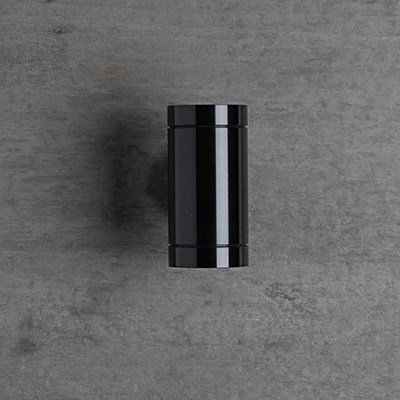 The Flexalighting Keller Double Emission wall light in black, mounted to a grey wall.