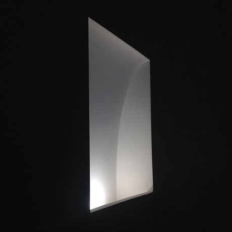 Architectural recessed rectangular LED light plastered into the wall, lit against a dark background