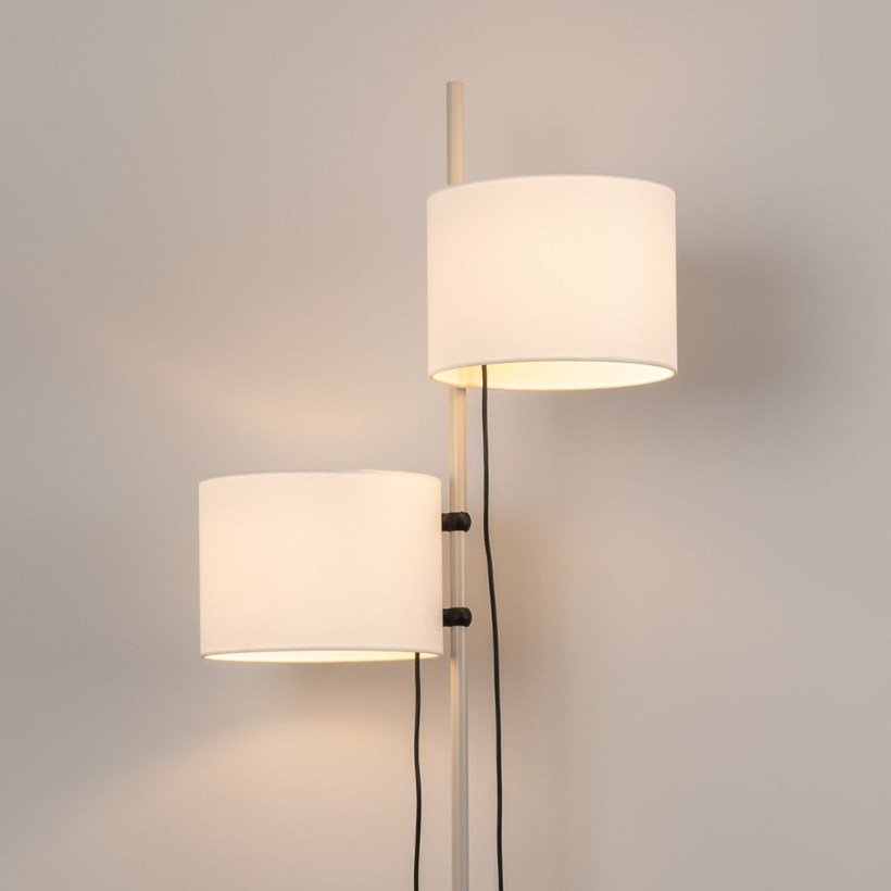Close up shot of free standing floor lamp, oak wooden finish with adjustable height lamp shades