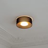 Ceiling mounted lid light by Milan Iluminacion with a black surround and a warm led bulb