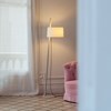 Single shade Linood light placed into a living room with a pink sofa