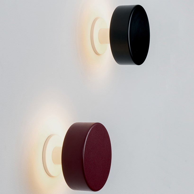 2 wall mounted peak lights, lighting up a wall, finished in red and black