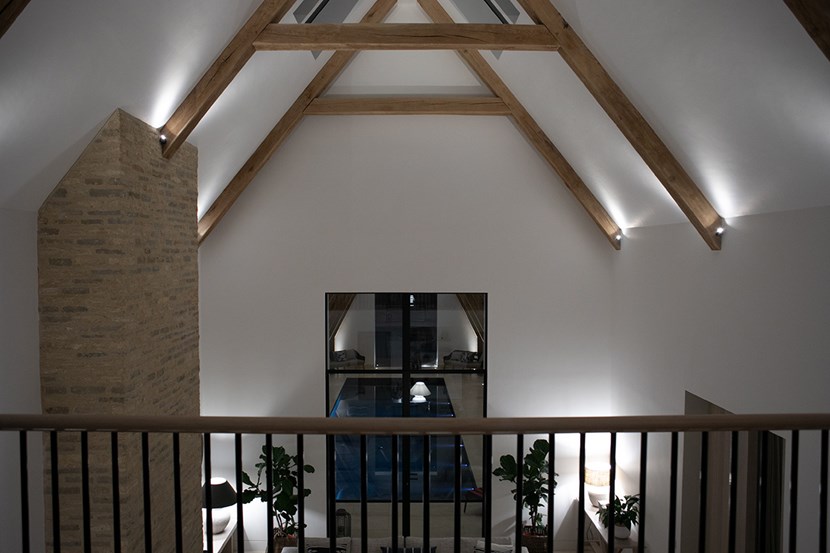 Lighting Design Pickwick indoor entertainment lounge space with ceiling eaves highlighted with spotlights