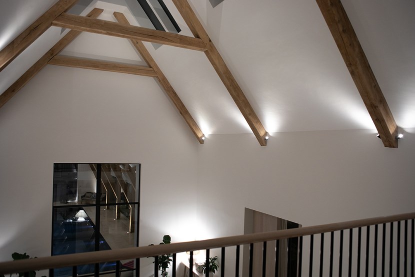 Lighting Design Pickwick indoor entertainment lounge space with ceiling eaves highlighted with spotlights