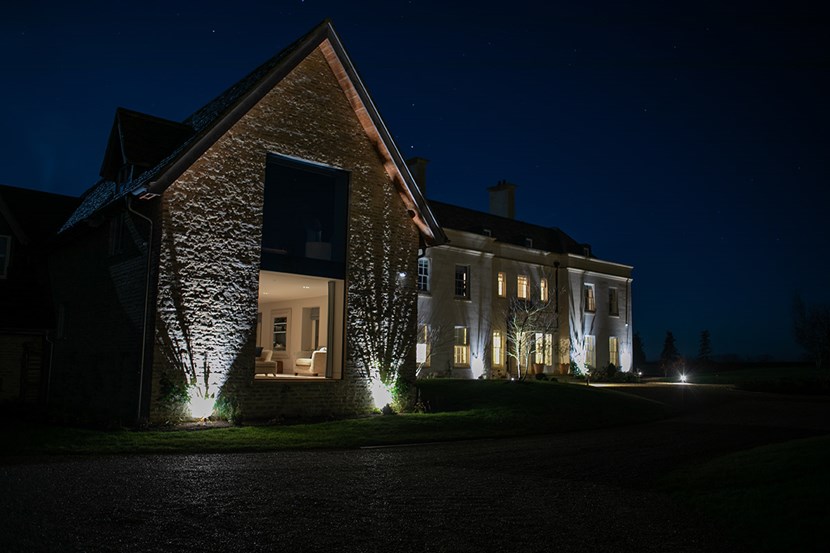 Lighting Design Pickwick outdoor shot of the front of the large country house at night, lit with uplights