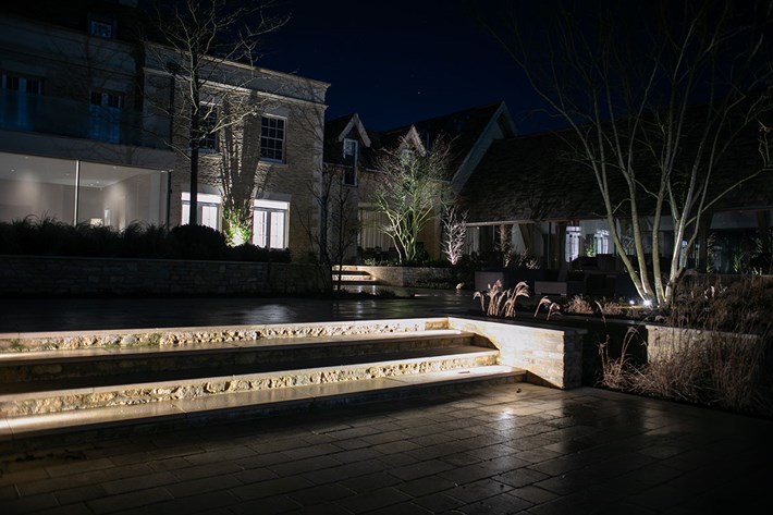 Lighting Design Pickwick outdoor shot of the beautifully landscaped garden, lit with uplights, pathlights and linear LED step lighting