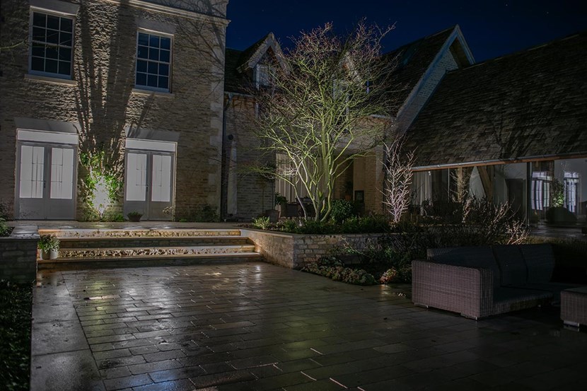 Lighting Design Pickwick outdoor shot of the beautifully landscaped garden, lit with uplights, pathlights and linear LED step lighting