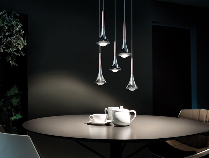 Cluster of 5 teardrop Lodes Rain pendants suspended over a round dining table & a white china tea set
