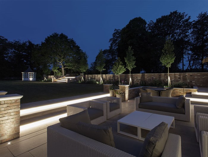 Contemporary patio garden at night with outdoor uprights, step lights, spotlights & exterior linear LED tape