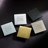 Rako EOS Wireless 6 push button wall plate in brass, matt black, matt white, matt bronze & chrome on dark bkgd