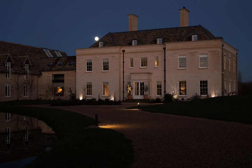 Lighting Design Oxfordshire outdoor shot of the grand front of the house at night, spotlights & pathlights