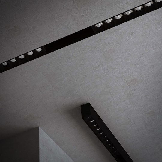Modular Lighting Systems: Shadowline plaster-in and surface mounted black track system installed in a dark ceiling