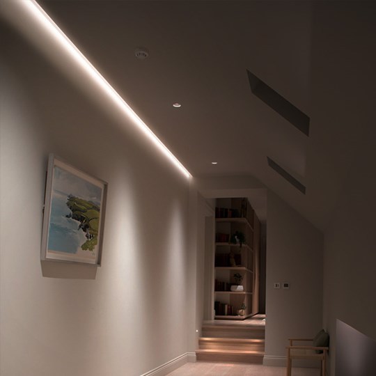 Linear LED profile providing ambient light in a hallway of.a contemporary home