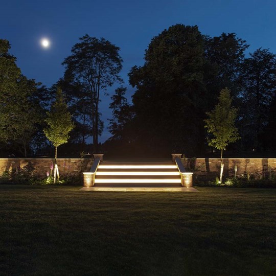 Outdoor Lighting: Contemporary patio garden at night with outdoor uprights, step lights, spotlights & exterior linear LED tape