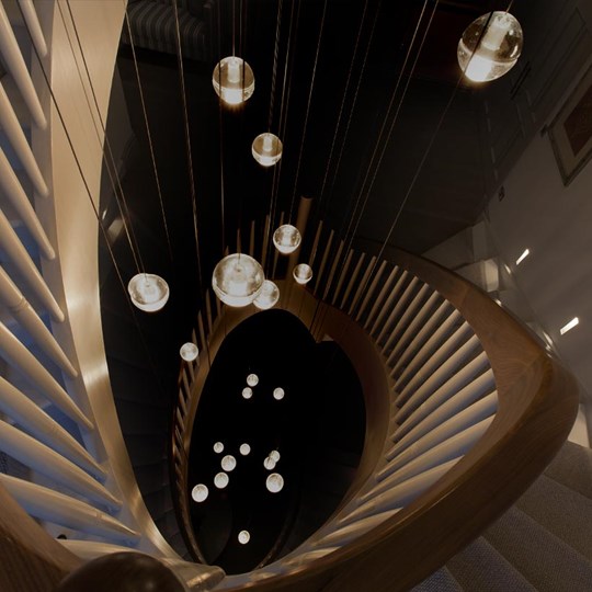 Premium Lighting Design - cluster of spherical glass Bocci pendants suspended down a 3 storey spiral staircase