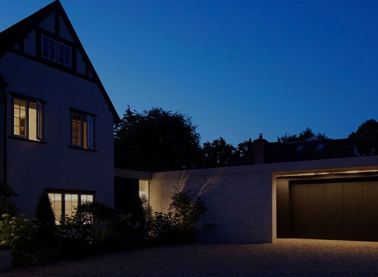 Project Portfolio: exterior of large home & garage at night