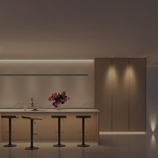 Interactive Lighting Design: contemporary kitchen, all lights on - ceiling linear lighting, downlights, breakfast bar light, linear pendant & floor uplight