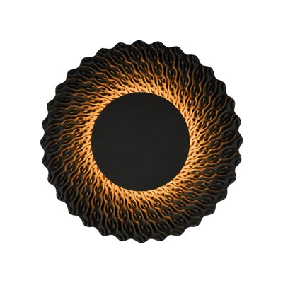 Round lamp made from black quartz sand emitting a warm glow