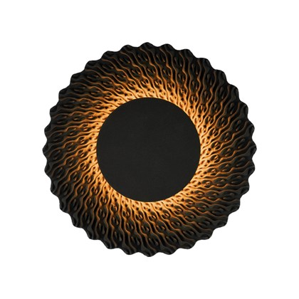 Round lamp made from black quartz sand emitting a warm glow