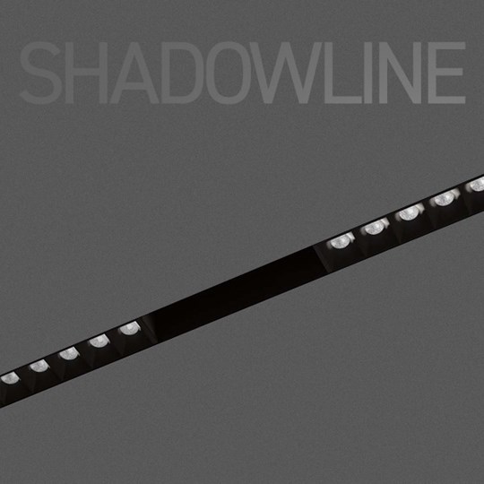 Shadowline track with spotlight modules in black on dark background, with overlaid typography