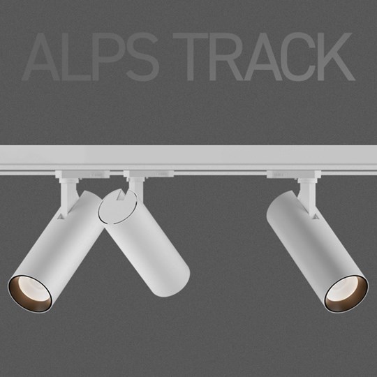 Alps track with 3 spotlights in white on dark background, with overlaid typography