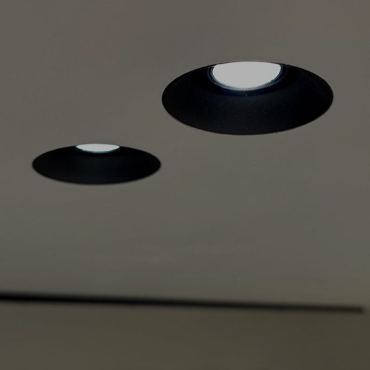 Architectural Lighting: Nebo trimless plaster-in adjustable black downlight installed in a ceiling